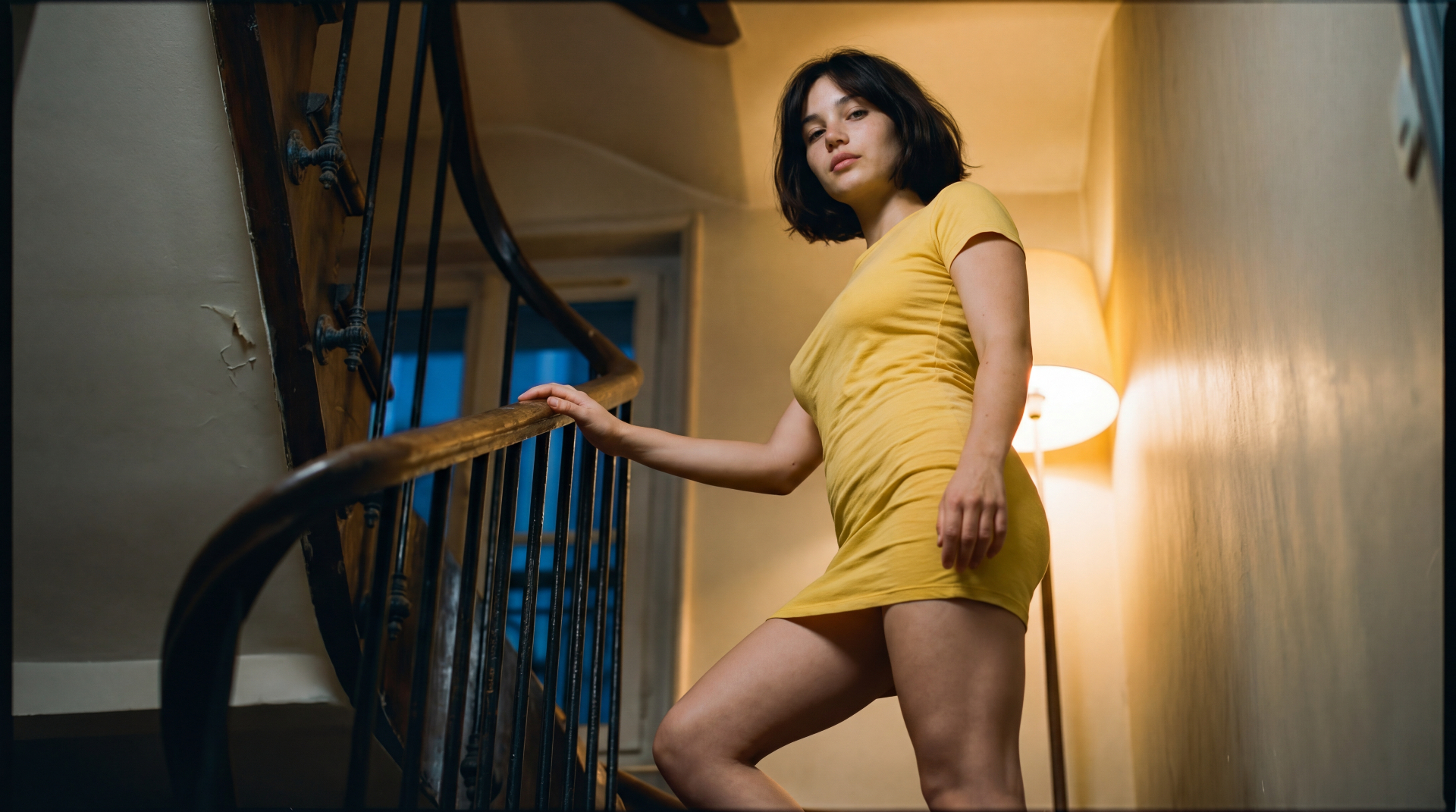 Belle on the old Parisian staircase, yellow dress glowing in lamplight